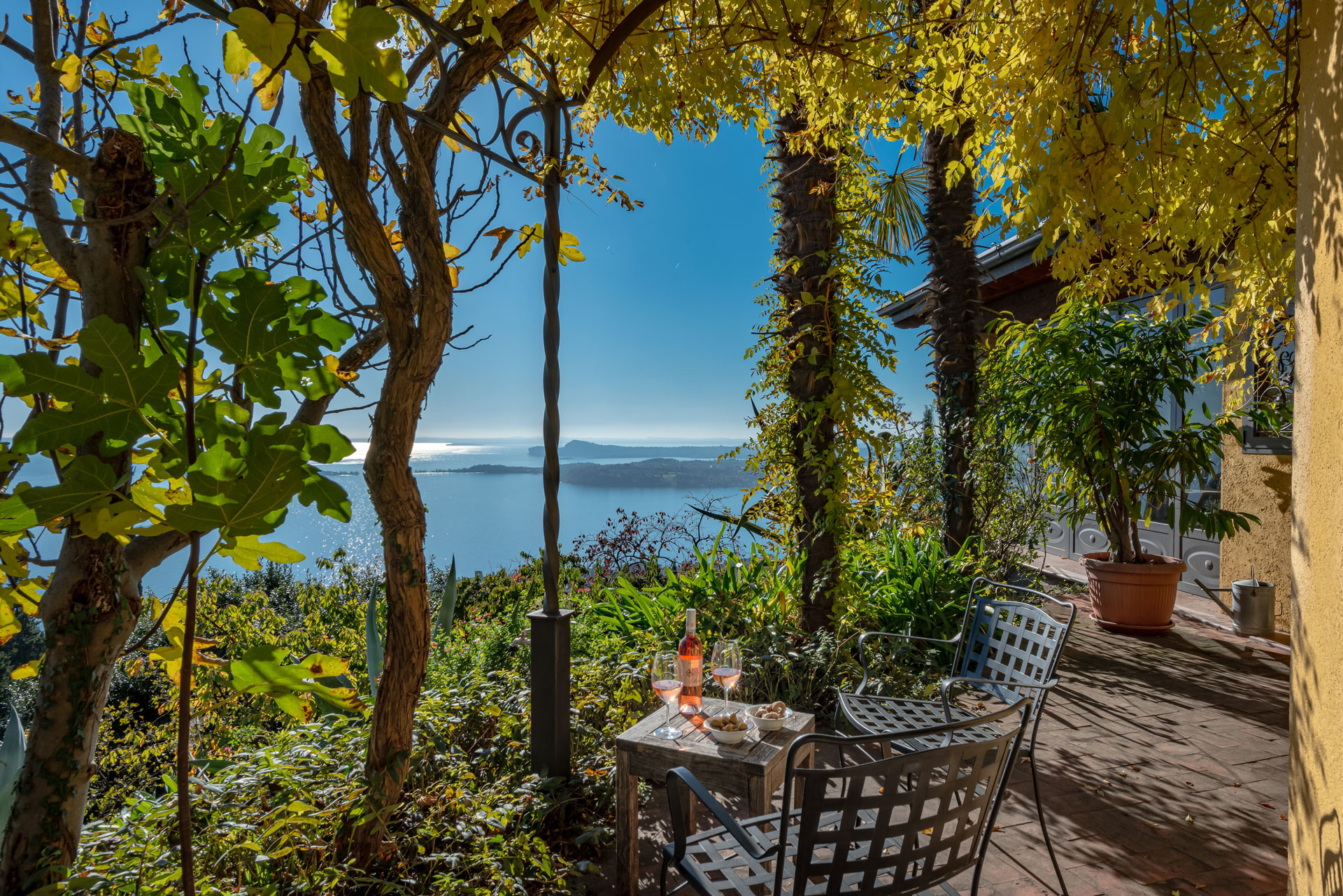 Terrace with wrought iron furniture and panoramic view of the lake